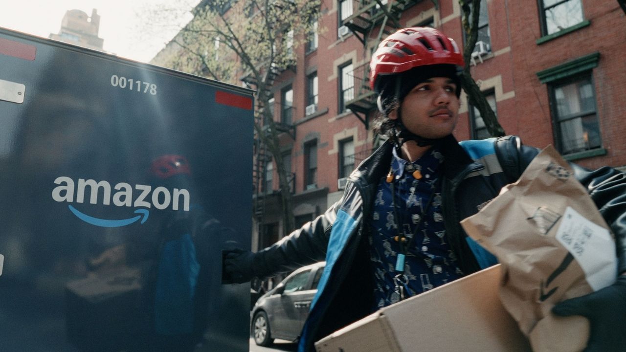 Amazon delivery person next to a box